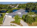 An aerial view of a sprawling blue home, showcasing a waterfront location and beautifully landscaped yard at 1310 91St Nw Ct, Bradenton, FL 34209