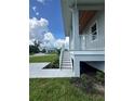 Classic porch with white railings, showcasing the entrance of a charming home at 14343 Myakka Ave, Port Charlotte, FL 33953