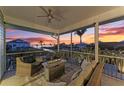 Relaxing screened-in porch with comfortable seating and views of the gorgeous sunset over the canal at 1918 Massachusetts Ave, Englewood, FL 34224