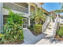 Attractive condo exterior with well-maintained landscaping, stairs, and screened porches at 2103 L Pavia Blvd # 2103, Venice, FL 34292