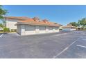 Detached condominium garages featuring red tile roofs and ample parking spaces at 2103 L Pavia Blvd # 2103, Venice, FL 34292