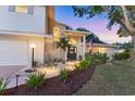 Charming home featuring landscaped front yard, brick accents, and covered entrance at 2111 Ivory Pl, Sarasota, FL 34239