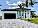 Newly built single-Gathering home with a modern design and an elegant driveway at 217 Rotonda S Blvd, Rotonda West, FL 33947