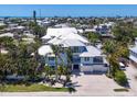 Aerial view of a stunning property with a metal roof, balconies, meticulous landscaping, and an oversized lot at 222 Willow Ave, Anna Maria, FL 34216