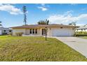 Attractive single-story home with an attached garage and well maintained landscaping at 2271 Pine View Cir, Sarasota, FL 34231
