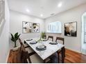 Elegant dining room with marble-top table, stylish chairs, and modern artwork; perfect for entertaining guests at 238 Cape Harbour Loop # 104, Bradenton, FL 34212