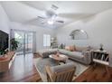 Bright living room featuring modern furnishings, stylish decor, and a sliding glass door for natural light at 238 Cape Harbour Loop # 104, Bradenton, FL 34212