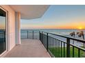 Balcony with stunning ocean views at sunset. A tranquil outdoor space offering captivating beachside scenery at 2525 Gulf Of Mexico Dr # 3F, Longboat Key, FL 34228