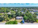 Aerial view of home nestled among mature trees with clear blue skies and a sense of neighborhood tranquility at 2538 Lakeshore Cir, Port Charlotte, FL 33952