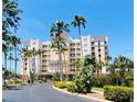 Elegant building exterior with lush tropical landscaping, palm trees, and a circular drive at 2715 Terra Ceia Bay Blvd # 504, Palmetto, FL 34221