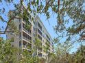 Multi-story building with exterior balconies framed by trees and blue skies at 2715 Terra Ceia Bay Blvd # 504, Palmetto, FL 34221
