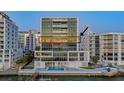 Modern high-rise building with a waterfront pool and access to a boat dock at 280 Golden Gate Pt # 600, Sarasota, FL 34236