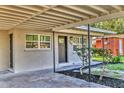 A close-up of the front entrance, featuring a covered carport and a modern front door at 2947 Goodrich Ave, Sarasota, FL 34234