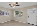Bright living room with tile floors, ceiling fan and abundant natural light from windows at 2947 Goodrich Ave, Sarasota, FL 34234