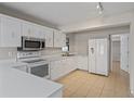 Bright kitchen with white cabinetry, stainless steel microwave, and tile flooring at 3505 27Th W Ave, Bradenton, FL 34205