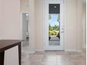 Bright entryway featuring neutral walls, tiled floor, and a view of the home's front door at 4814 Lake Breeze Ter, Sarasota, FL 34243