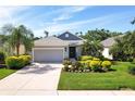 Charming single-story home featuring manicured landscaping and an attached two-car garage at 4814 Lake Breeze Ter, Sarasota, FL 34243