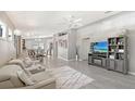 Open-concept living room with gray walls, modern furniture, ceiling fan, and wood-look floors at 4838 San Ortebello Dr, Bradenton, FL 34208