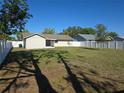 Spacious backyard with lush green grass and a newly installed white privacy fence at 5002 26Th Avenue Dr E, Palmetto, FL 34221