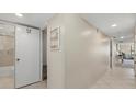 Hallway view with an open bathroom and a view of the living room area at 5780 Midnight Pass Rd # 410, Sarasota, FL 34242