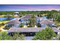 Aerial view of property with covered parking, water views, and lush landscaping at 623 Estuary Dr, Bradenton, FL 34209