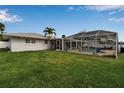A spacious backyard features a screened-in pool, perfect for outdoor entertaining at 6422 Beechwood Ave, Sarasota, FL 34231