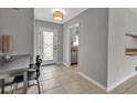 View of the home's bright entryway leading to the kitchen with stainless steel appliances at 6422 Beechwood Ave, Sarasota, FL 34231