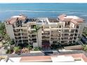 Elegant condo building boasts multiple balconies with water views and manicured landscaping at 6460 Mourning Dove Dr # 102, Bradenton, FL 34210