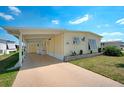 Charming single-story home with a covered carport and a well-maintained lawn at 649 Fairmount Dr, North Port, FL 34287