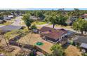 Aerial view of backyard with screened-in porch, fenced yard, and green fire pit at 6547 Samoa Dr, Sarasota, FL 34241