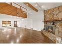 Open living room with wood floors, stone fireplace, and vaulted ceilings at 6547 Samoa Dr, Sarasota, FL 34241