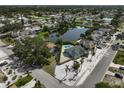 Stunning aerial view of a beautiful home with a private pool and waterfront views of a serene lake at 6924 34Th W Ave, Bradenton, FL 34209