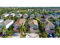 Aerial view showcases the property's location within a residential neighborhood with lush landscaping and nearby amenities at 7168 Chatum Light Run, Bradenton, FL 34212
