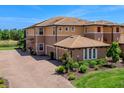 Stunning multi-Gathering home featuring a paver driveway and a two-car garage at 7425 Divot Loop, Lakewood Ranch, FL 34202