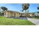 Single story home with a covered area, well-kept lawn, and located on the water at 780 Jungle Queen Way, Longboat Key, FL 34228