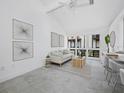 Bright living room featuring neutral decor, a comfortable sofa, and ample natural light through expansive windows at 800 S Blvd Of The Presidents # 19, Sarasota, FL 34236