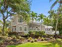 Charming two-story home with meticulously landscaped front yard and inviting entrance at 8871 Fishermens Bay Dr, Sarasota, FL 34231