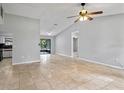 Spacious living area featuring tile flooring, vaulted ceiling, and access to the kitchen and backyard at 920 36Th W St, Bradenton, FL 34205