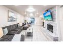 Spacious living room featuring a stone fireplace, plush sectional sofa, and sliding glass doors at 104 Shoreland Dr, Osprey, FL 34229