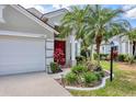 Charming home featuring well-manicured landscaping and a welcoming red door at 11236 Beebalm Cir, Lakewood Ranch, FL 34202