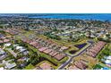 Breathtaking aerial view of a neighborhood with lush greenery, water features, and stunning waterfront property at 1203 Calle Grand St, Bradenton, FL 34209
