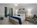 Serene main bedroom with a plush bed, elegant lighting, and decorative accents at 12440 Wellen Golf St # 105, Venice, FL 34293