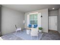 Inviting outdoor patio featuring stylish seating, a patterned rug, and a welcoming ambiance at 12440 Wellen Golf St # 105, Venice, FL 34293