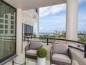 Relaxing balcony featuring outdoor seating and panoramic views of the waterfront at 1255 N Gulfstream Ave # 402, Sarasota, FL 34236