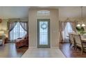 Bright foyer featuring tile flooring, chandelier, and dining and living spaces at 12805 Raysbrook Dr, Riverview, FL 33569