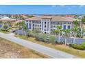 Stunning exterior view of a multi-story building with meticulous landscaping and architectural details at 1349 Aqui Esta Dr # 143, Punta Gorda, FL 33950