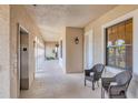 Well-lit hallway featuring neutral tones, a window with natural light, and seating area near elevator at 1349 Aqui Esta Dr # 143, Punta Gorda, FL 33950