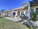 Charming villa with a welcoming front patio featuring seating and beautiful garden, creating a cozy and inviting atmosphere at 1526 Mission Hills Blvd # 18B, Clearwater, FL 33759