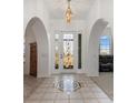 Inviting foyer with decorative tile, arched doorways and a stylish light fixture at 17343 Cayo Ln, Punta Gorda, FL 33955