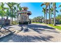 Gated community entrance surrounded by lush palm trees and landscaping at 2084 La Palma Ave, Port Charlotte, FL 33953